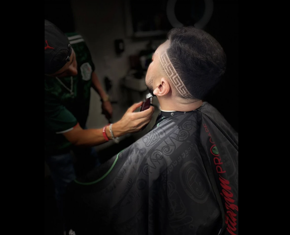 Greca Greek-key pattern shaved into the side of a client's head at Cultura Barbershop